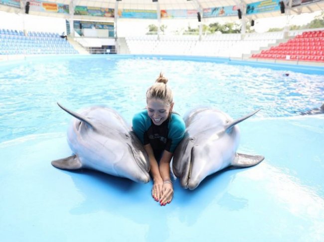 Вера Брежнева в бассейне вместе с двумя дельфинами